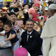 A child cries as his mother holds him up to Pope Francis in Seoul, Korea.